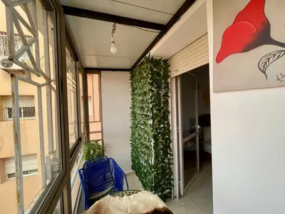 a living room with a plant on the wall at Beautiful family apartment with parking in Marrakech