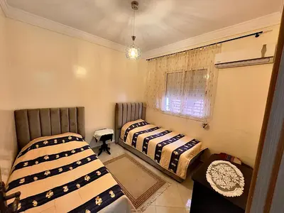 two beds sitting in a room with a window at Maison Marocaine de Farah in Marrakech