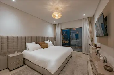 a bedroom with a large white bed and a window at Premium stay in Guéliz-Hivernage in Marrakech