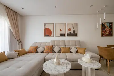 a living room with a large couch and two tables at Premium stay in Guéliz-Hivernage in Marrakech