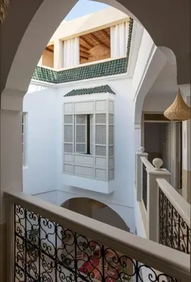 a stairway with a white wall and a window at Riad privé Dar Sun 2 bassins & Rooftop coeur medina in Marrakech