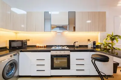 a kitchen with a stove and a washer and dryer at Apartment in Center of Marrakech in Marrakech