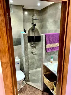 a bathroom with a shower and a toilet and a sink at Appartement avec piscine privée in Marrakech
