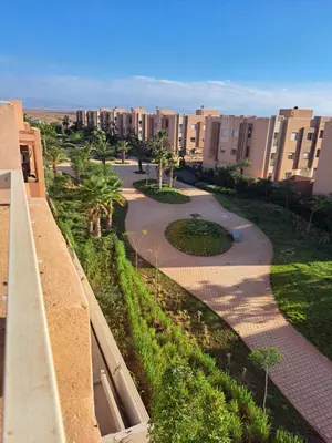 arial view of a city with buildings and palm trees at Appartement avec piscine privée in Marrakech
