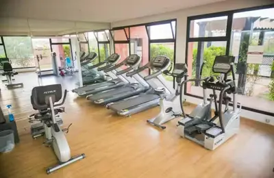a gym with a bunch of treadms and cardio machines at Superbe appartement Marrakech Piscine Wifi Climatisation in Marrakech