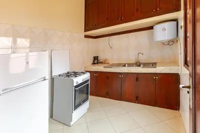 a kitchen with a white stove and a refrigerator at Jamila home elegance hospitality fiber WiFi in Marrakech