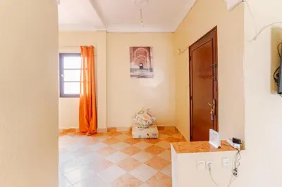 a room with an orange curtain and a door at Jamila home elegance hospitality fiber WiFi in Marrakech