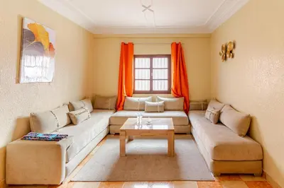 a living room with a couch and a table at Jamila home elegance hospitality fiber WiFi in Marrakech