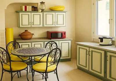 a kitchen with a table and chairs and a microwave at Appart AMITAF in Marrakech