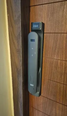 a cell phone is hanging on a wooden door at Comfortable poolside apartment near city center in Marrakech