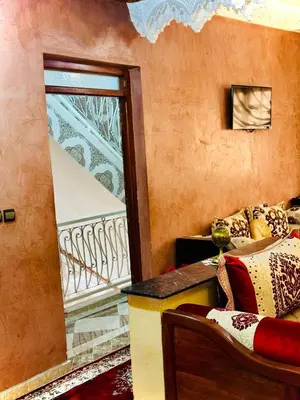 a living room with a couch and a balcony at Marrakech mhamid in Marrakech