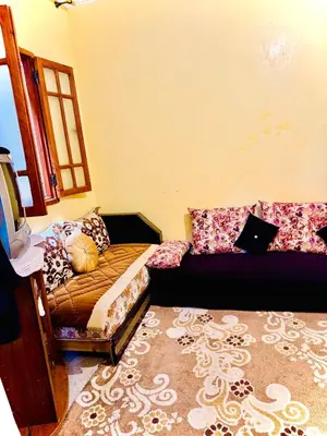 a living room with a couch and a bed at Marrakech mhamid in Marrakech