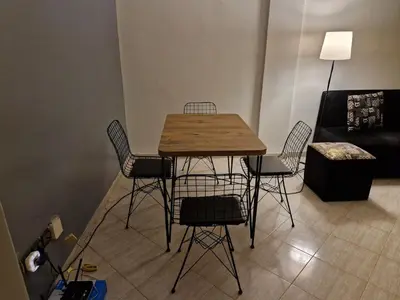 a table and chairs in a living room with a couch at cozy appartement in Marrakech