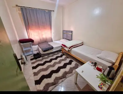 a small room with two beds and a table at cozy appartement in Marrakech