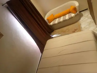 a bed in a room with a window at Chambre unique in Marrakech