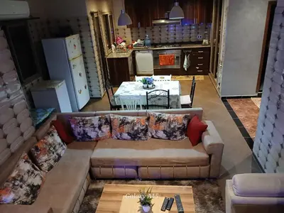 a living room with a couch and a table at Chambre unique in Marrakech