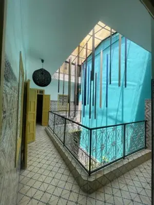 a building with a balcony with a pool in it at Khamsa in Marrakech