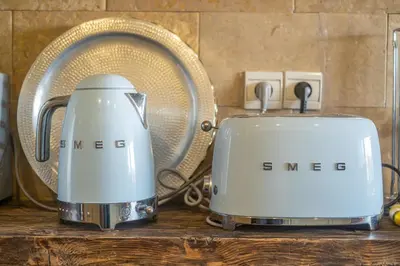 two toasters sitting on a counter next to a fan at Stylish 2BR With Balcony & Designer Touches in Gueliz in Marrakech