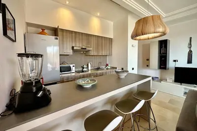 a kitchen with a counter with a blender on it at Sunny apartment with rooftop Water Park included in Dar Caïd Layadi