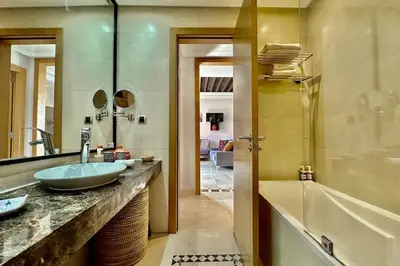 a bathroom with a sink and a tub at Sunny apartment with rooftop Water Park included in Dar Caïd Layadi