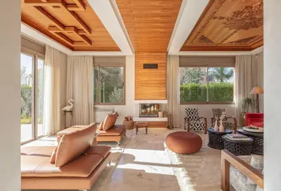 a living room with a couch and a fireplace at Villa Dar Saliha in Ala el Ma