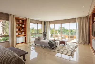 a bedroom with a bed and a couch and windows at Villa Dar Saliha in Ala el Ma