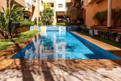 a swimming pool in the middle of a building at jnane awrad du 18 novembre in Marrakech