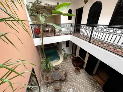 an overhead view of a balcony with a table at Charming private riad with pool in Marrakech
