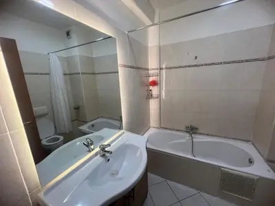 a bathroom with a sink and a tub and a toilet at Cozy appartement au centre de marrakech in Marrakech
