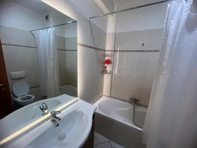 a bathroom with a sink and a tub and a toilet at Cozy appartement au centre de marrakech in Marrakech