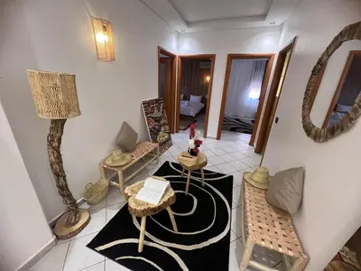 a living room with a table and a lamp at Cozy appartement au centre de marrakech in Marrakech
