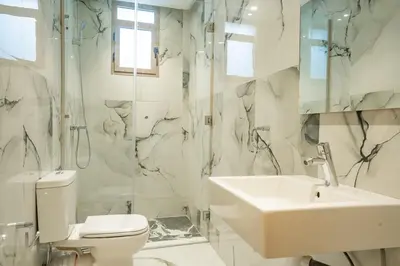 a bathroom with a sink and a toilet and a shower at Petit Palm in El Rhechat