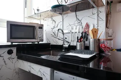 a kitchen with a counter top with a microwave at Marjane Allal Fassi 2 chambres Bedrooms 2 Bathrooms Wi-Fi fibre climatisation in Marrakech
