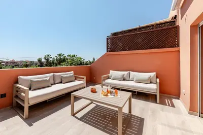 a patio with two couches and a table at Penthouse with Rooftop and Jardin Majorelle View in Marrakech