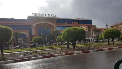 a building in a city with trees in front of it at LA PERLE ANDALOUSE Quartier HIVERNAGE in Marrakech
