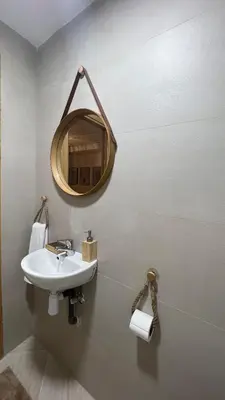 a bathroom with a sink and a mirror on the wall at La perle d'atlas appartement in Marrakech