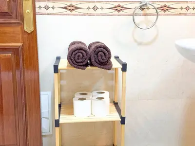 a towel rack in a bathroom with towels at Elegant 2-BR, Pool And Parking Hivernage Centre in Marrakech