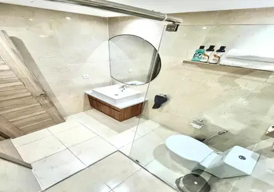 a bathroom with a toilet and a sink and a mirror at havre de paix in Marrakech
