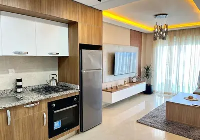 a kitchen with a stainless steel refrigerator in a room at havre de paix in Marrakech