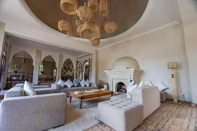 a large living room with couches and a fireplace at Villa des SONGES in Marrakech
