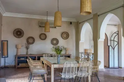 a dining room with a table and chairs at Villa des SONGES in Marrakech