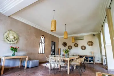 a dining room with a table and chairs at Villa des SONGES in Marrakech