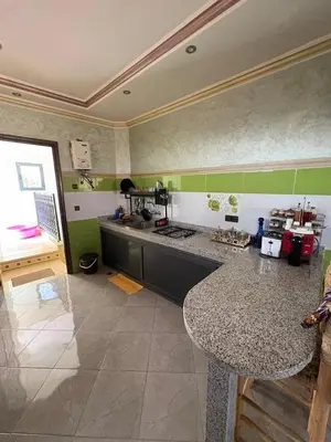 a kitchen with a counter top in a room at Airport appartement , penthouse in Marrakech