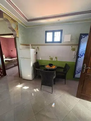 a kitchen with a refrigerator and a table and chairs at Airport appartement , penthouse in Marrakech