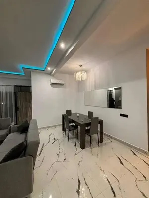 a dining room with a table and a couch at Appartement moderne in Marrakech
