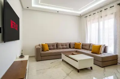 a living room with a couch and a table at Modern Studio in Hivernage with Pool Access in Marrakech