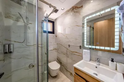 a bathroom with a shower and a toilet and a sink at Modern Studio in Hivernage with Pool Access in Marrakech