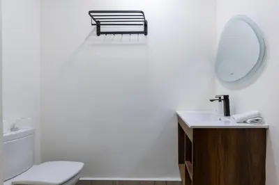 a bathroom with a toilet and a sink and a mirror at 4 Bed Villa lagune River Palm Marrakech with Pool in Marrakech