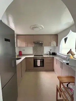 a kitchen with an archway in the middle of it at Riad Marrakech in Marrakech