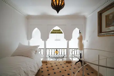 a bedroom with a bed and a balcony at Nahla Wellness in Marrakech